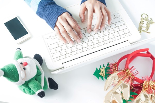 Laptop workspace with festive décor, illustrating the use of seasonal keywords.
